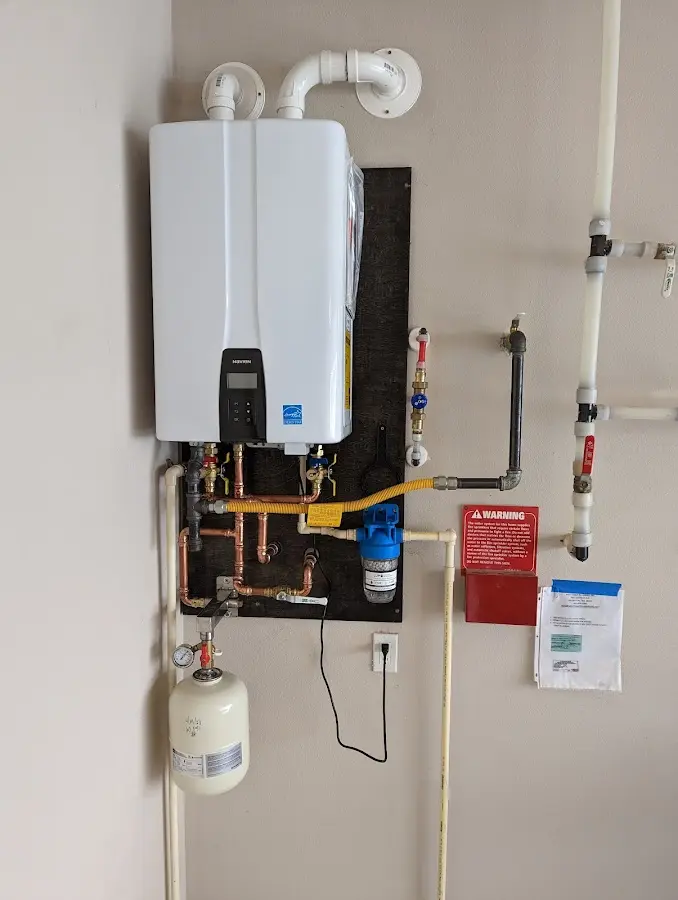 Professional plumber installing copper piping in a North Londonderry home